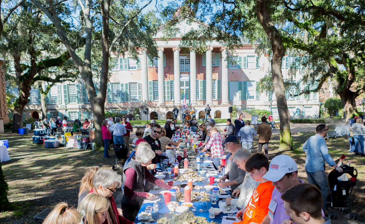 People eating oysters at an oyster roast in Cistern Yard