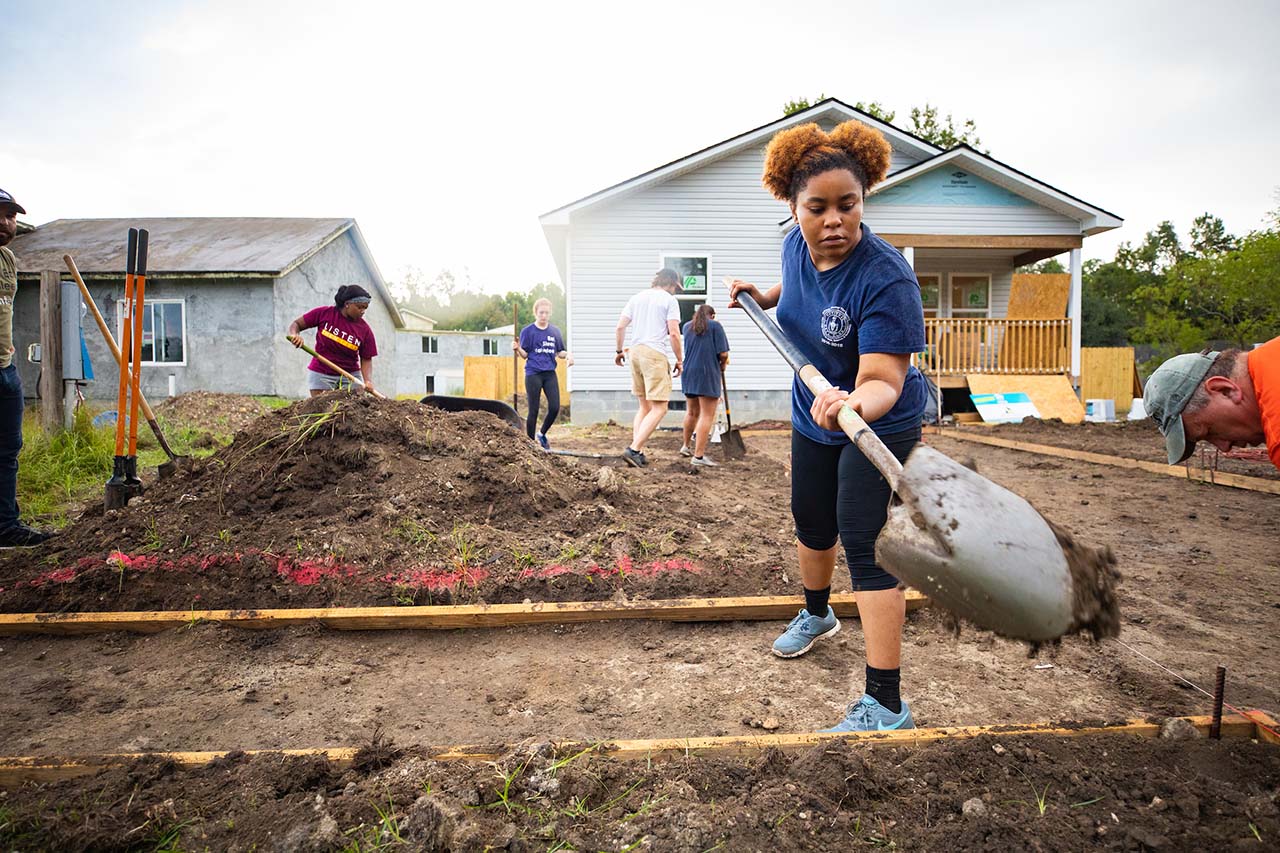 A student volunteers at habitat for humanity