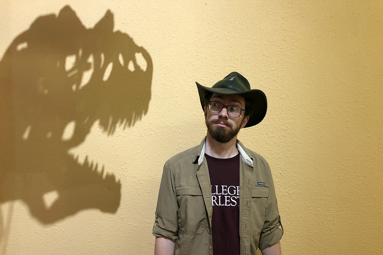 scott persons looks at the shadow of dinosaur