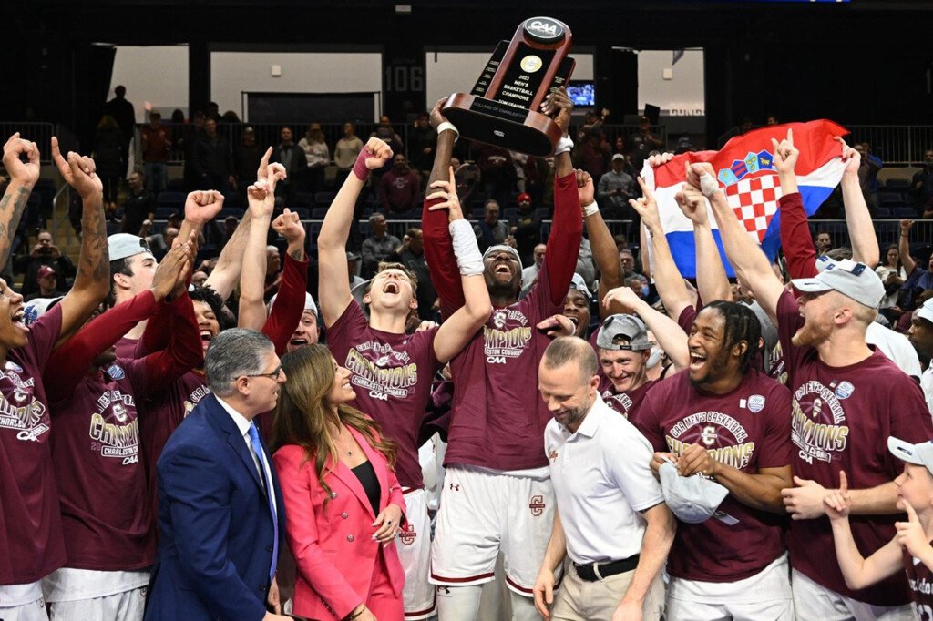 cofc men's basketball with caa trophy