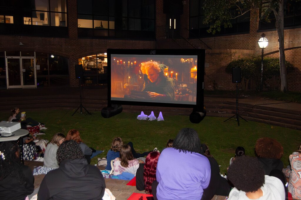 students get cozy to watch a halloween movie together