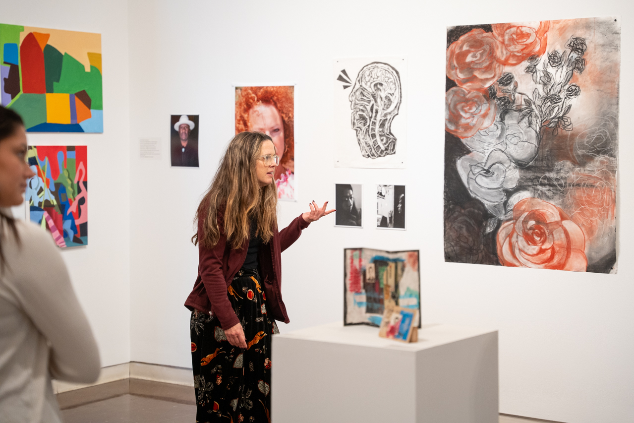Art teacher discusses student art work in the Halsey Gallery 