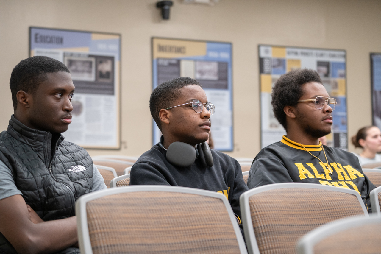 black students listen to Dr. Antron Mahoney speak  