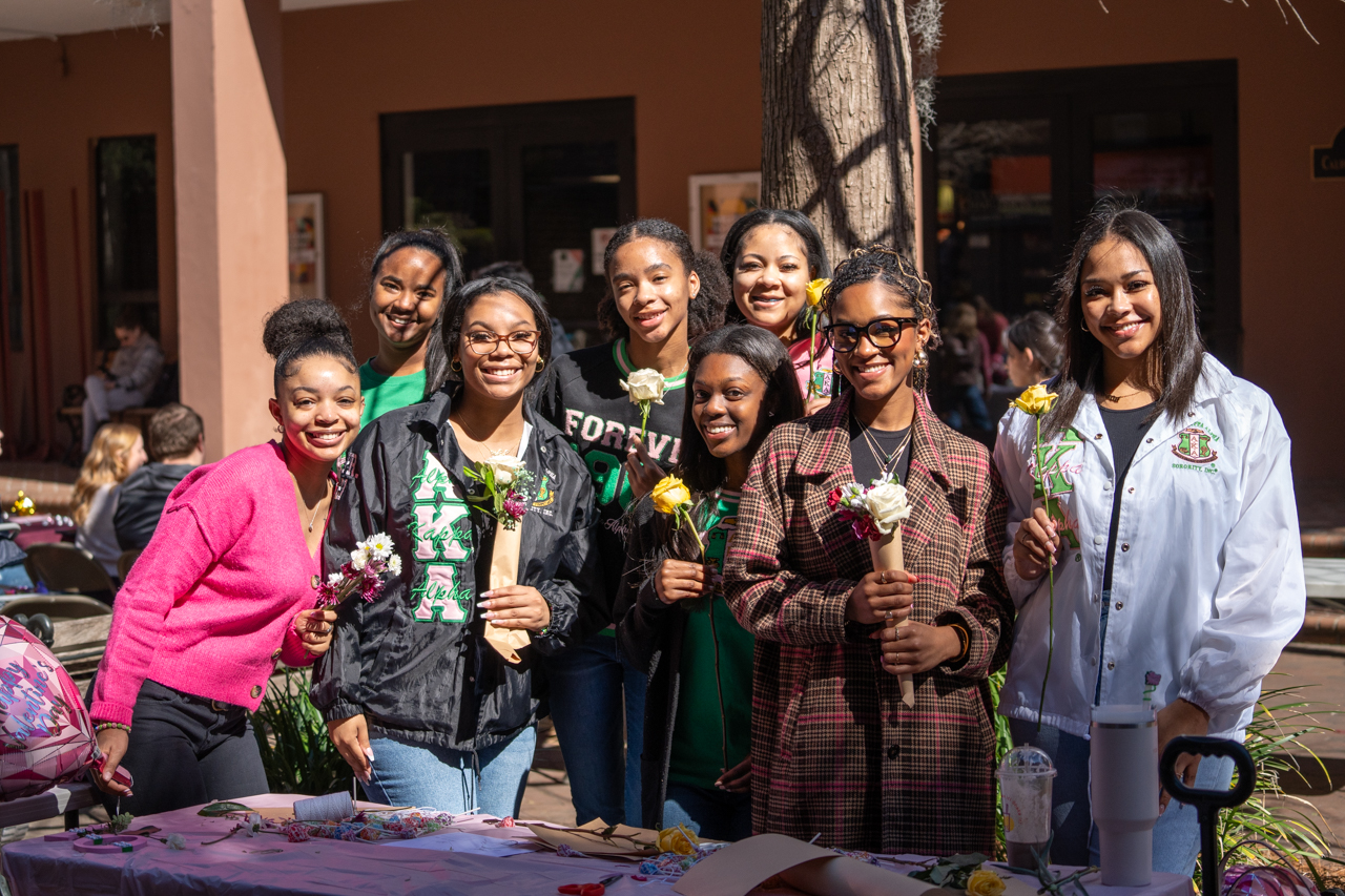 Sorority poses for photo with flowers for valentines day 