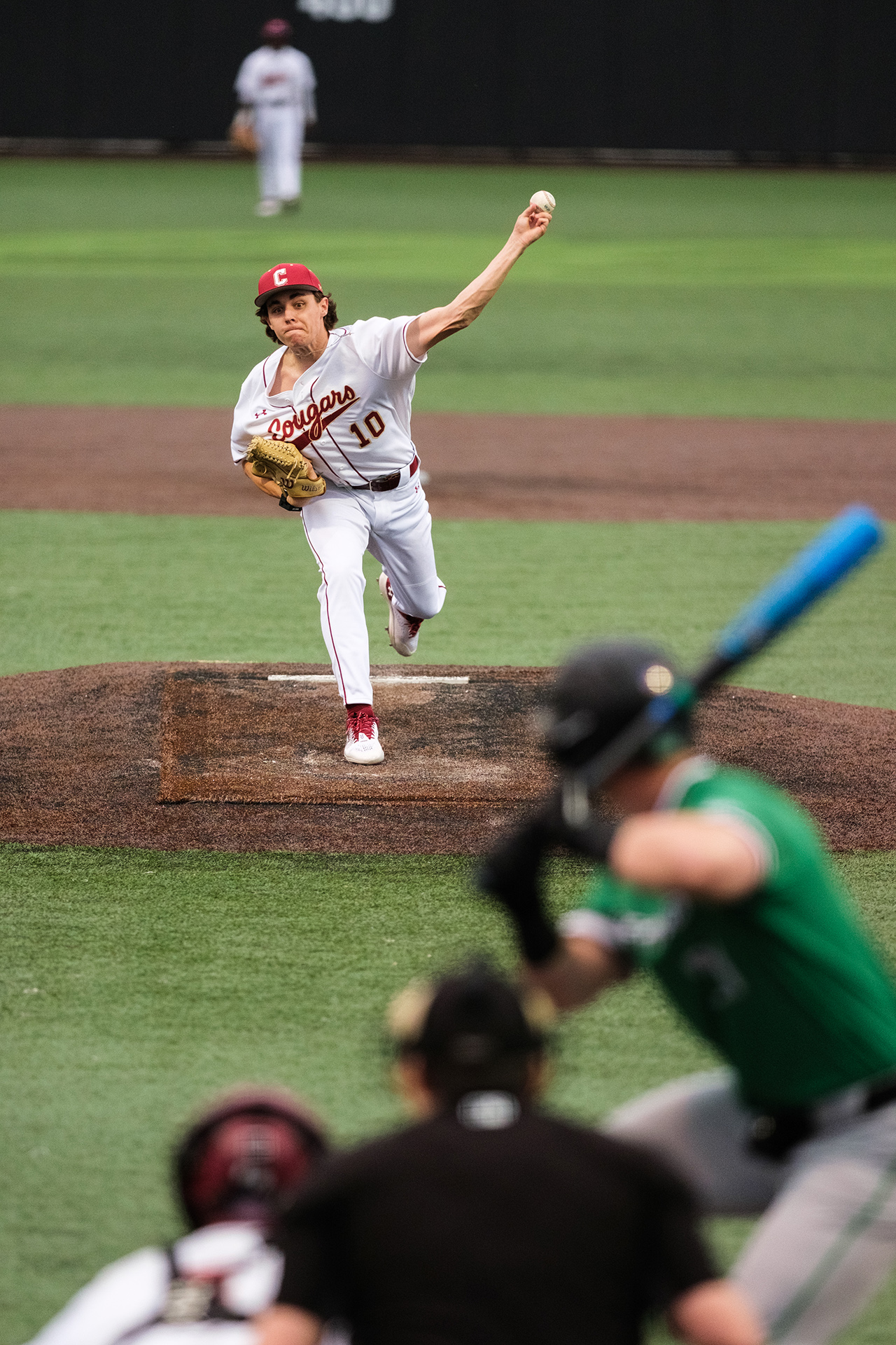 pitcher throws a ball at the batter 