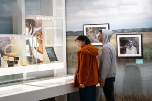 Two students viewing artifacts inside a museum. 