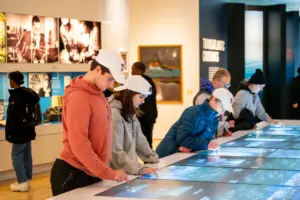 A group of students viewing artifacts inside a museum. 