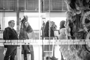 Several students viewing a museum exhibit.