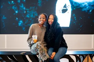 Two student sitting on a bench inside the African American museum.