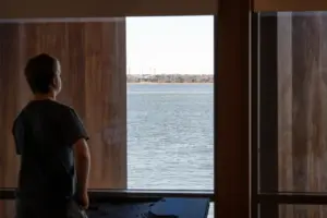 A student viewing the Charleston Harbor on the balcony of the museum. 