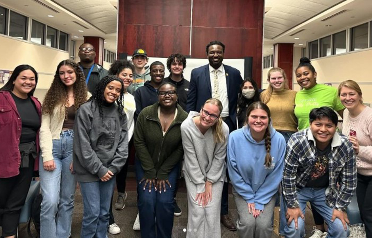 SC State Representative Jermaine Johnson poses with students