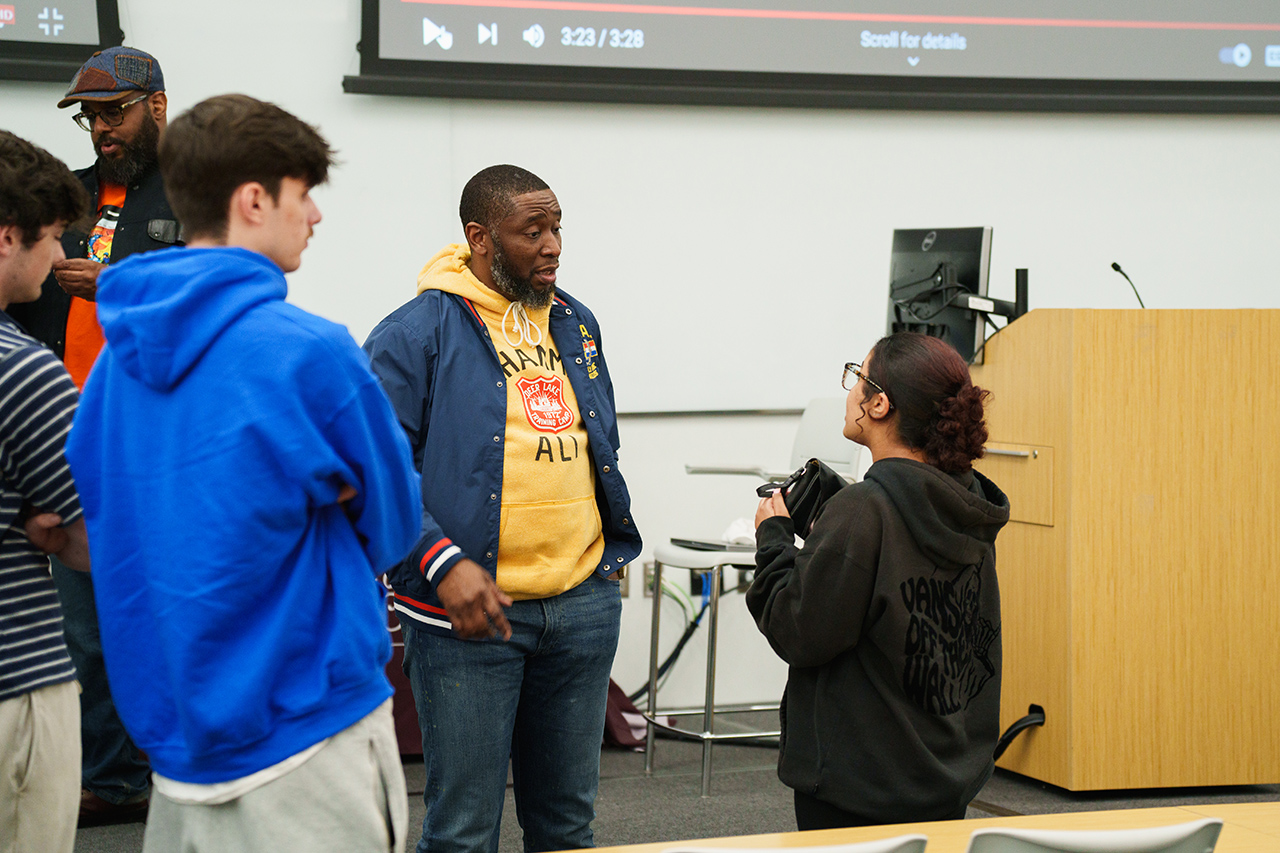 student asks questions of 9th Wonder during his visit to CofC