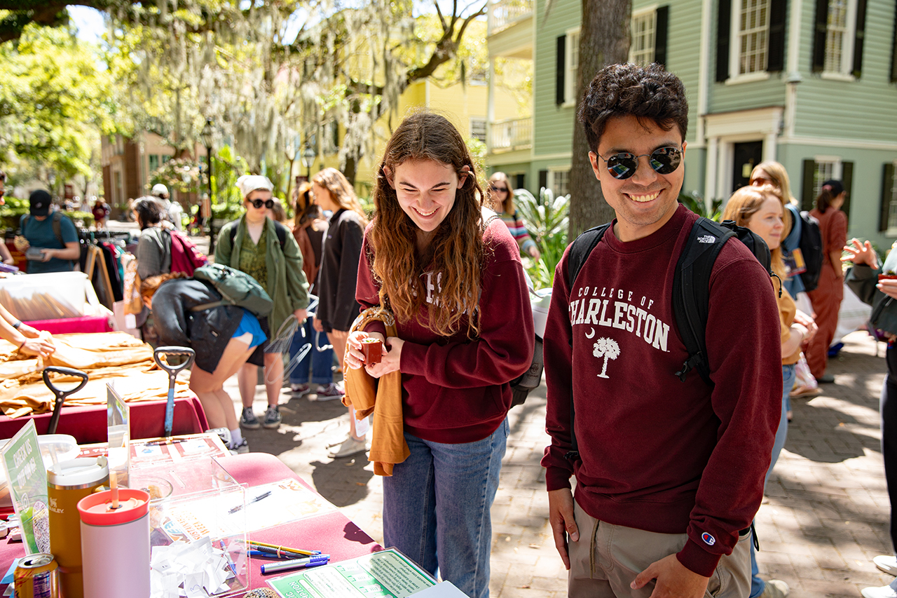 CofC student interacting with Honors Engaged booth at Sustainability Fair.