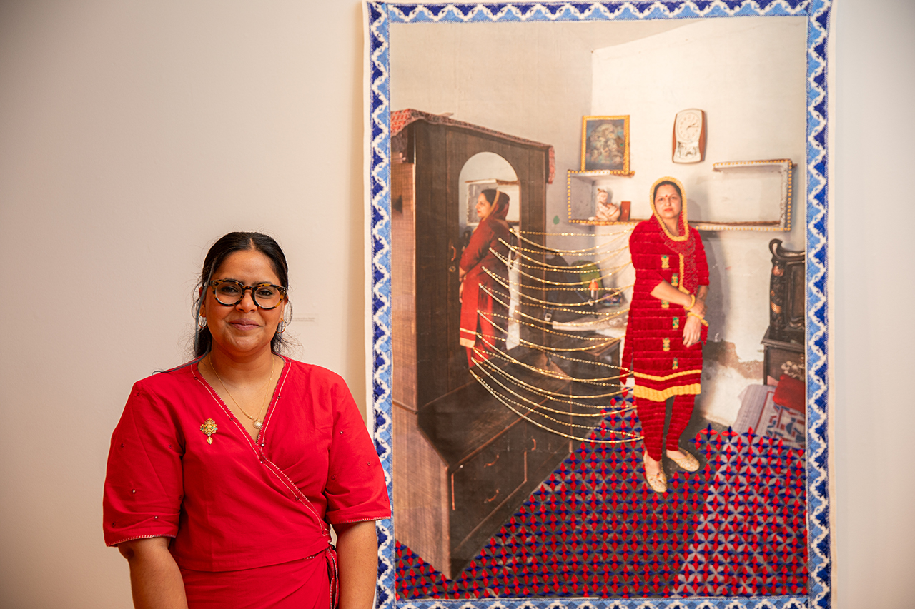 Spandita Malik, featured Halsey artist, poses in front of one of her works.