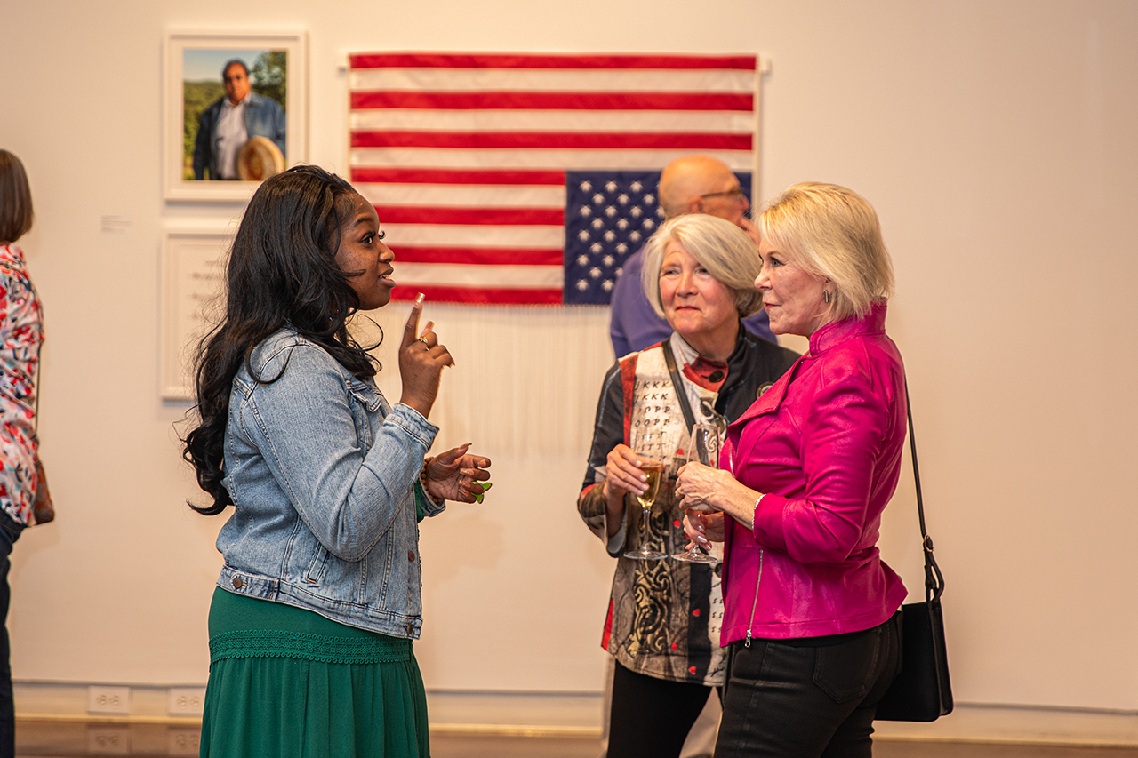 Halsey attendees mingle at Harkins' exhibit titled Teach Me a Song.