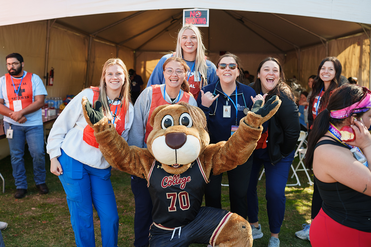 Clyde poses with runners at Bridge Run Finish