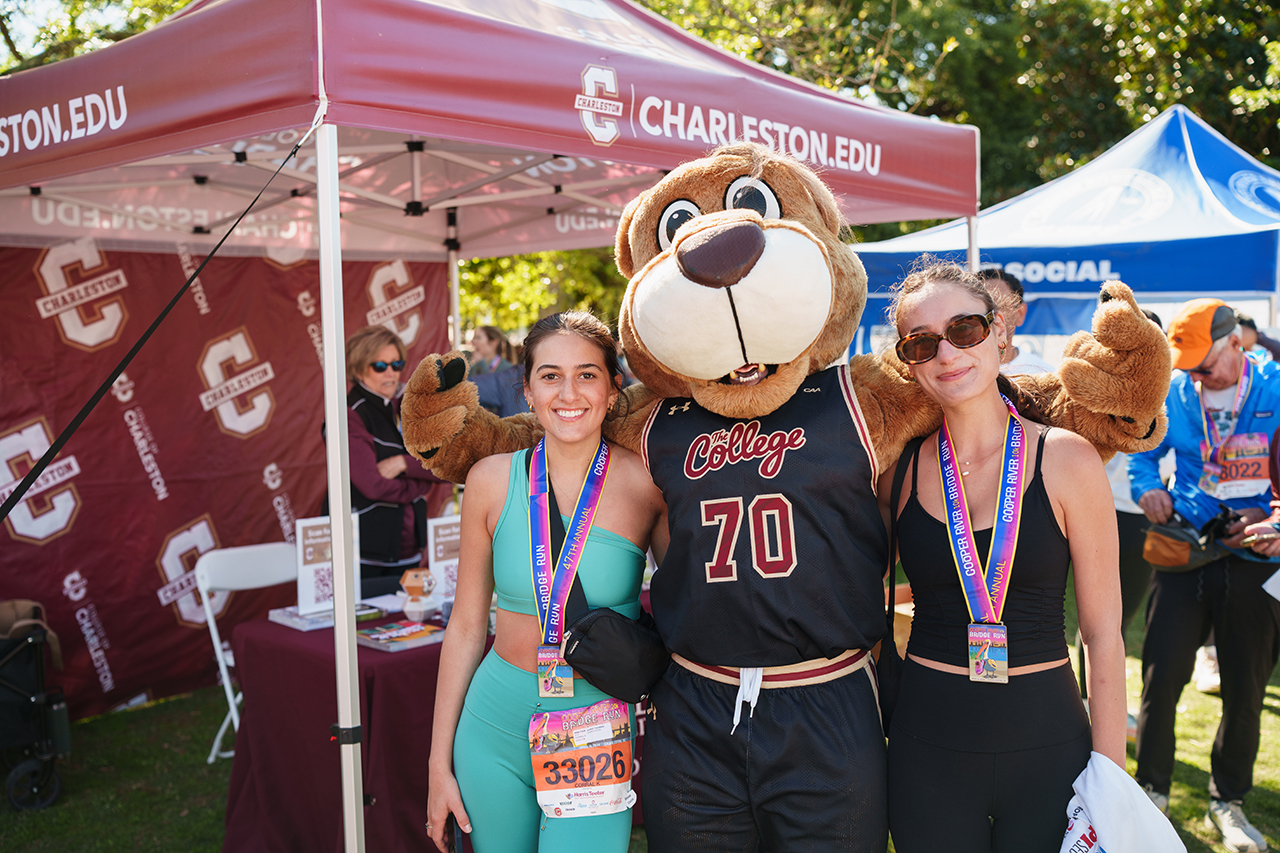 Clyde poses with runners at Bridge Run Finish