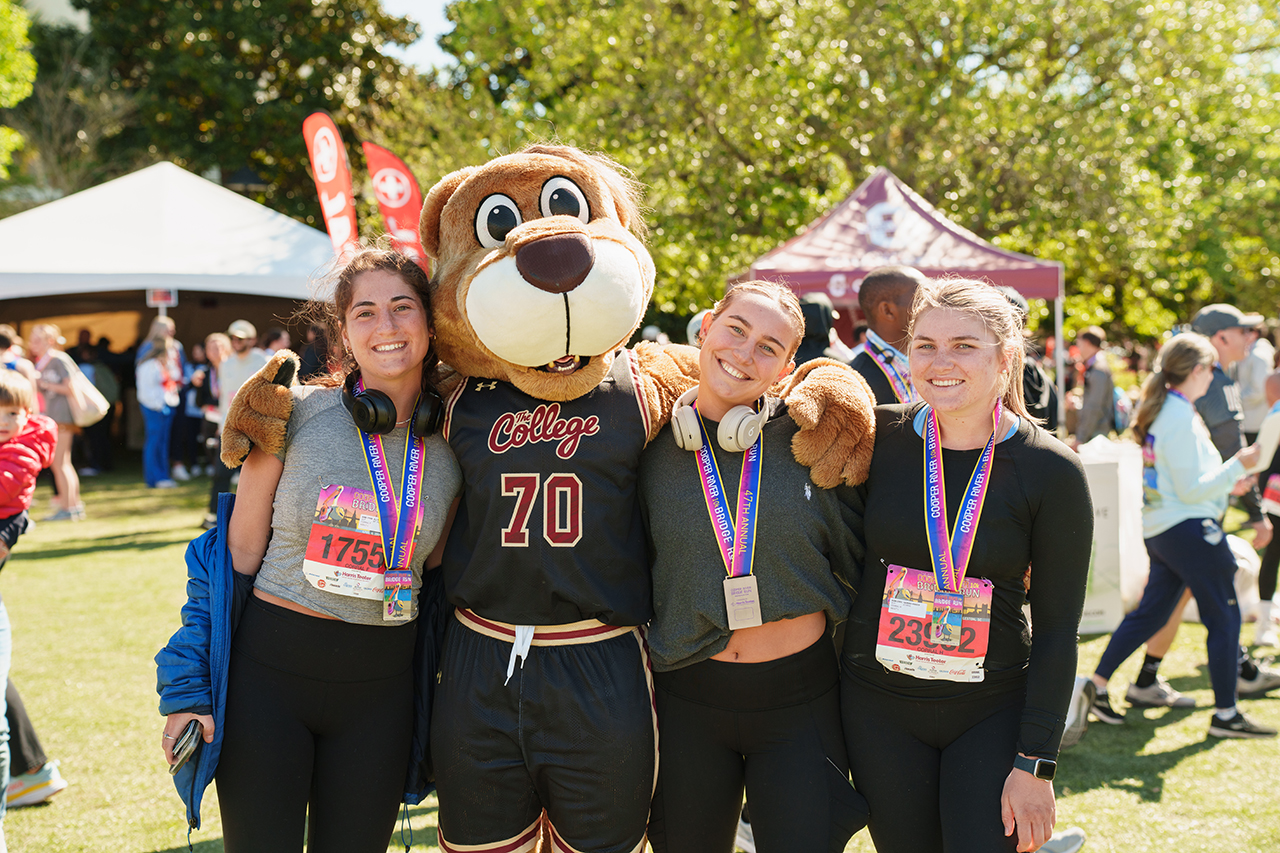 Clyde poses with runners at Bridge Run Finish