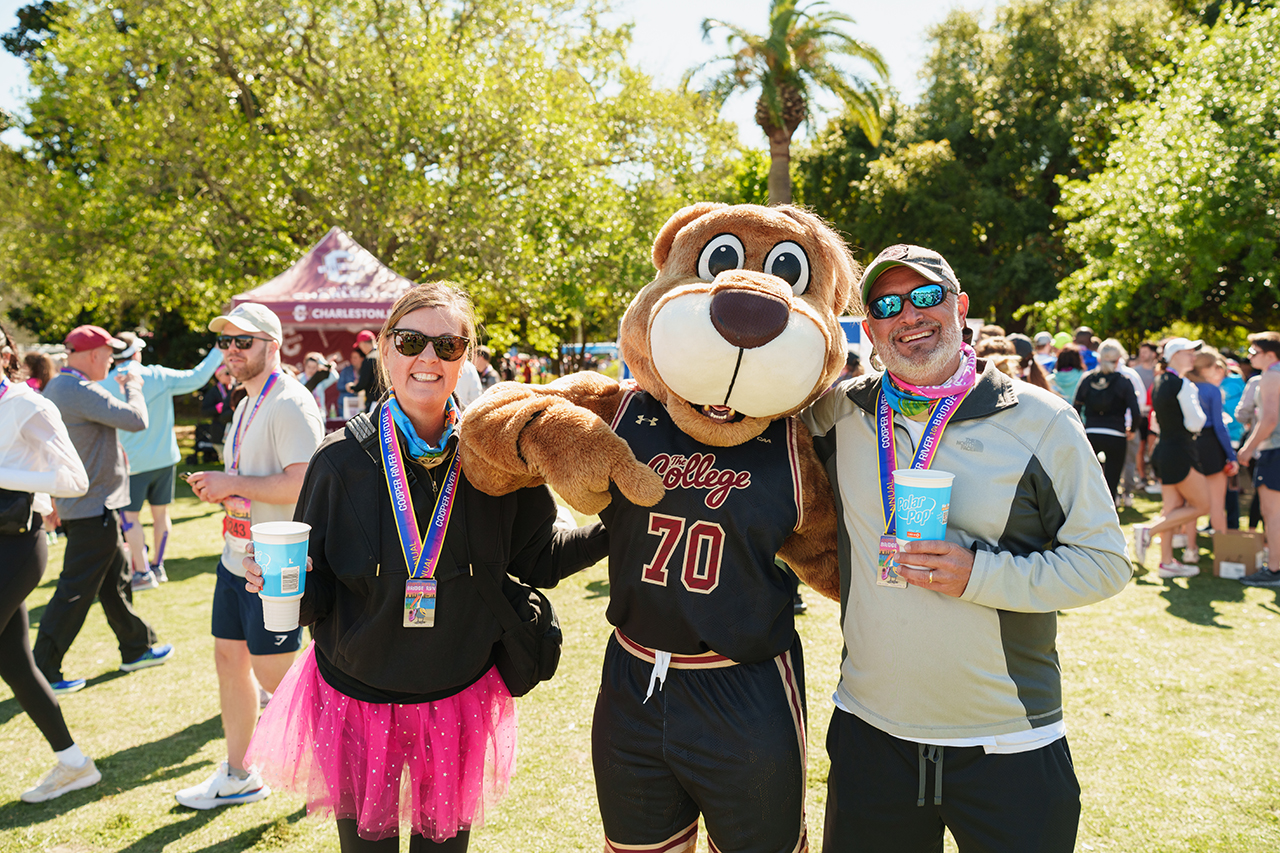 Clyde poses with runners at Bridge Run Finish