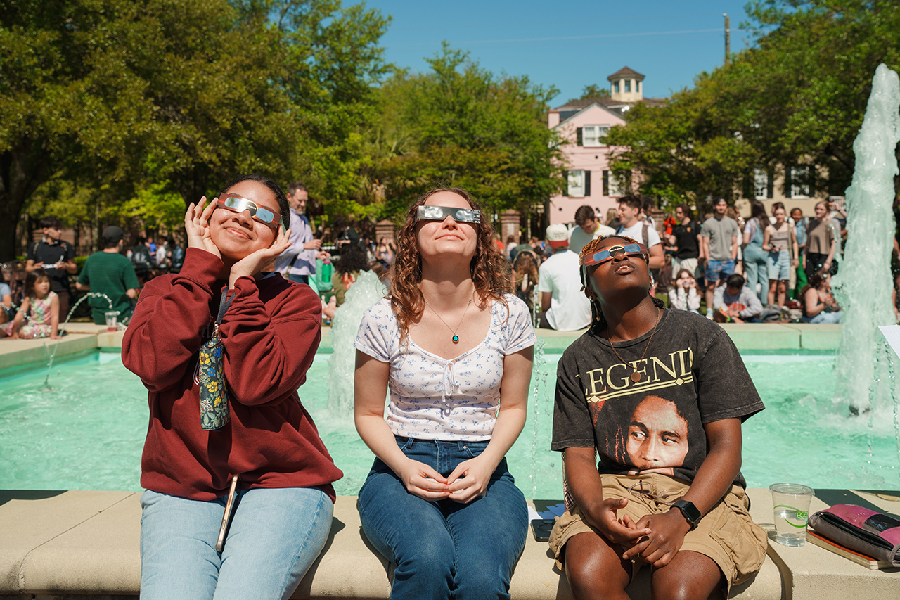 Students gather on Rivers Green looking up at the partial Solar Eclipse 