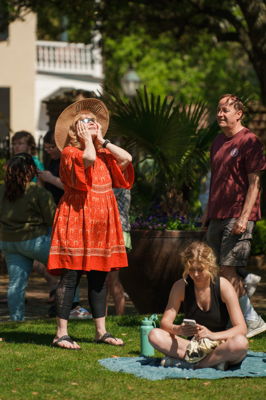 Students gather on Rivers Green looking up at the partial Solar Eclipse 