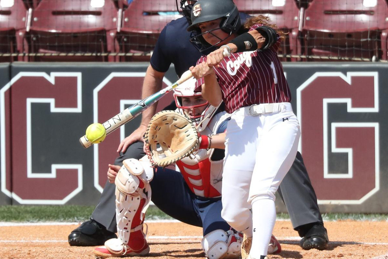 softball player hitting ball