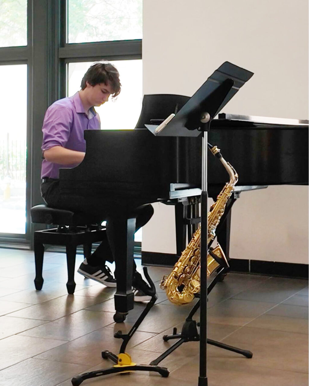 Student plays piano during young artist series 