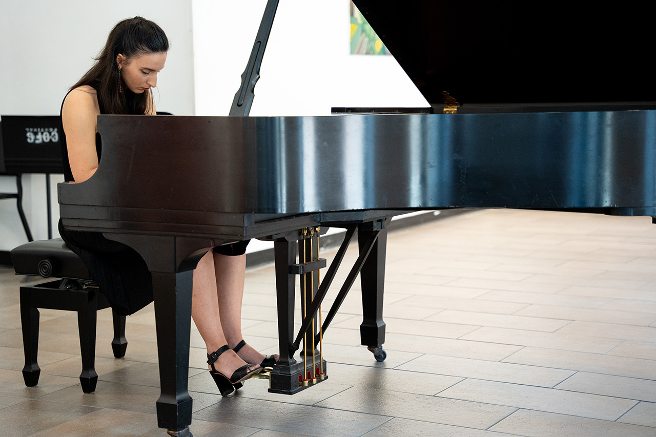 Student plays piano during young artist series 