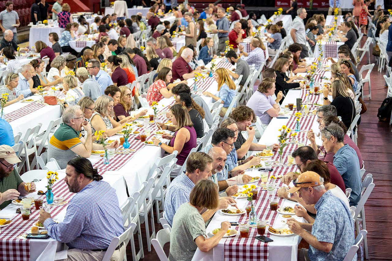 many people sitting at tables eating