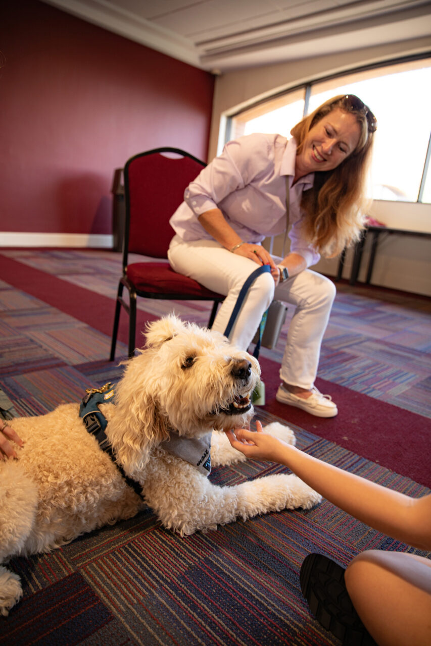 Students pet dog at the dog therapy event put on by Students 4 Support.