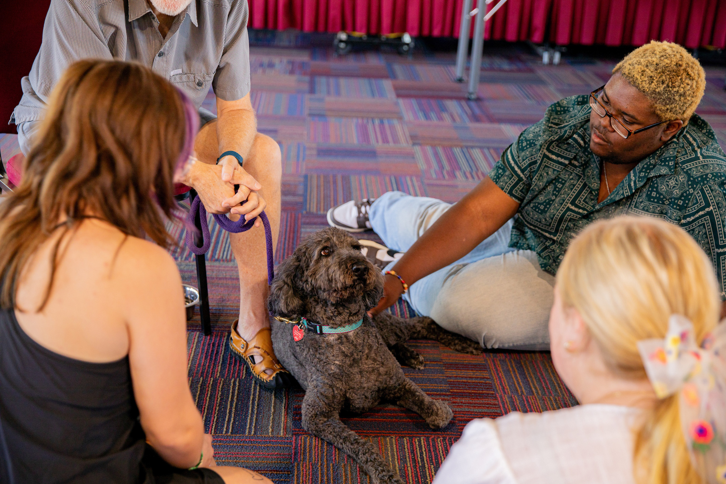 Students pet dog at the dog therapy event put on by Students 4 Support.