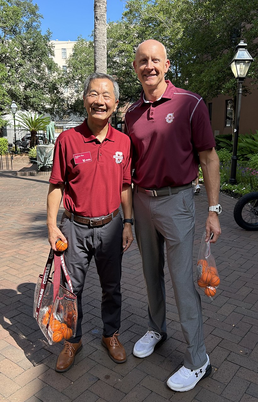 President Hsu and the new basketball coach hand out mini basketballs on campus 