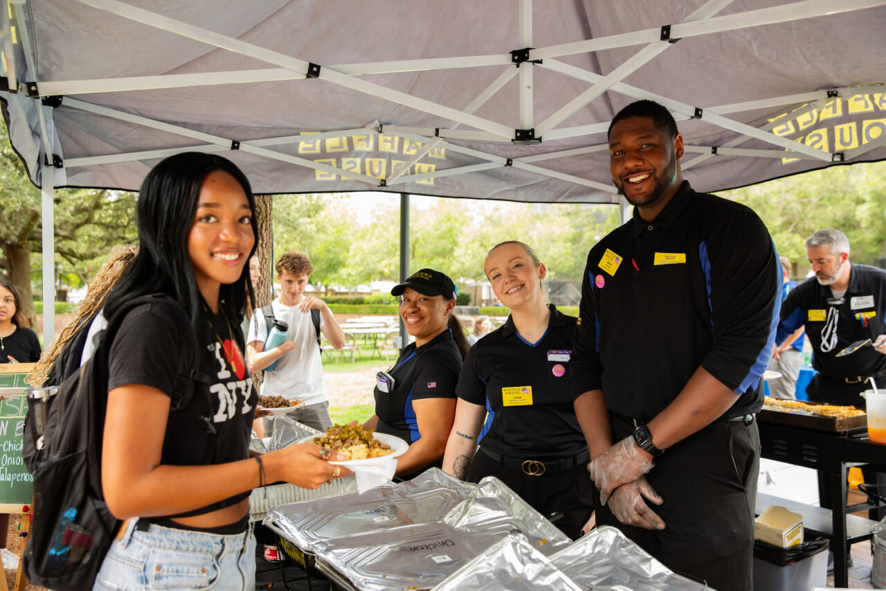 Representatives from Waffle House serve students at Careers Cookout.