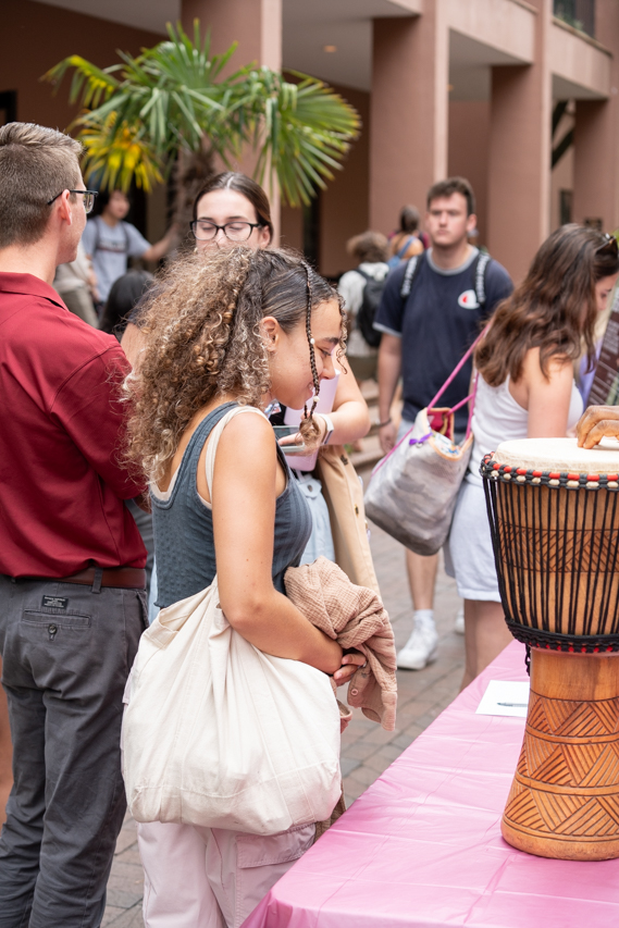 walking by a drum at the Study Abroad Fair in the Cougar Mall