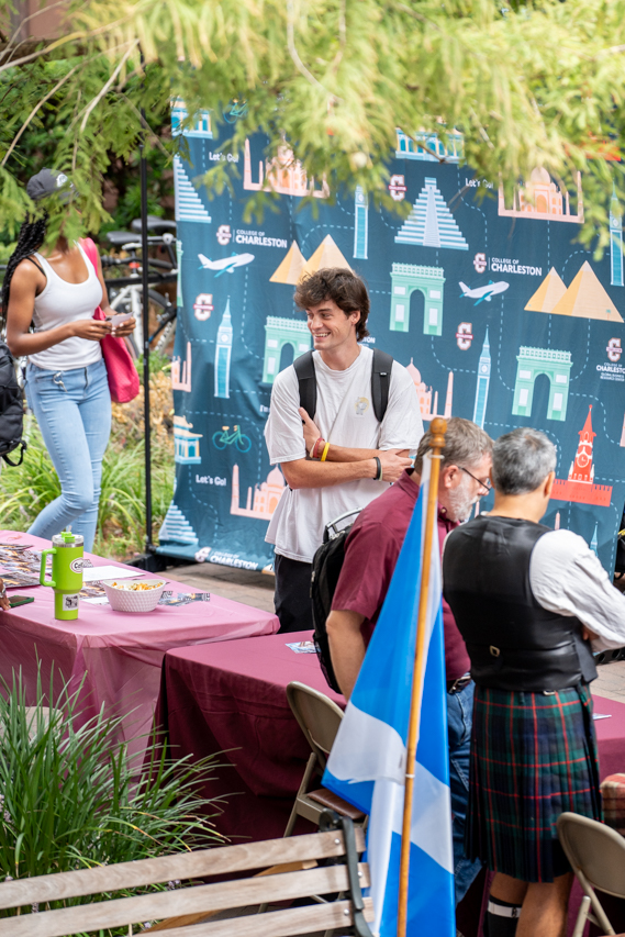 student smiles and gathers information at the Study Abroad Fair 