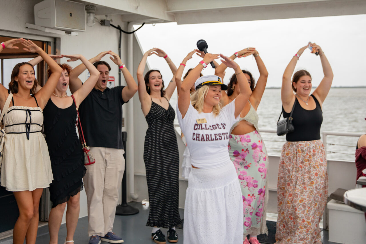 Students do a group dance at CAB Harbor Cruise event.