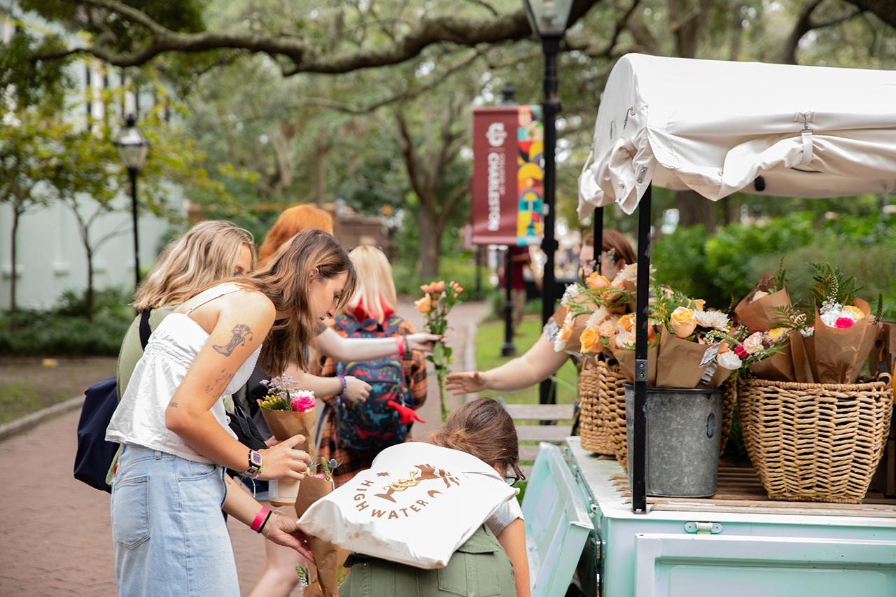 Students pick their own free flower bouqet at Sweet Jessamine Flower Truck at Sottile Clock.