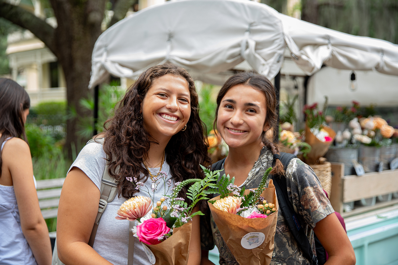 Students pick their own free flower bouqet at Sweet Jessamine Flower Truck at Sottile Clock.