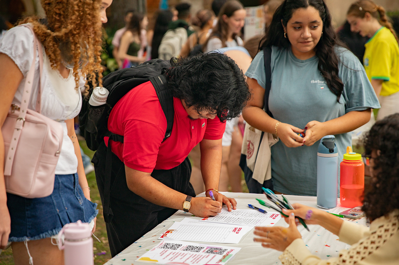 Student stops by ASL Club booth at HLC Multicultural Festival in Cistern.