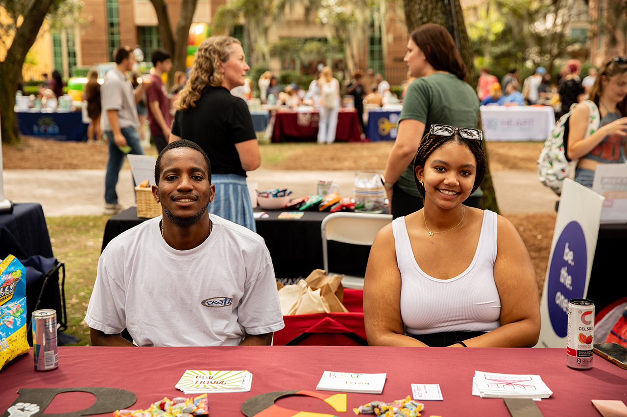 Students represent the Black Student Union at a booth at the Involvement Fair.