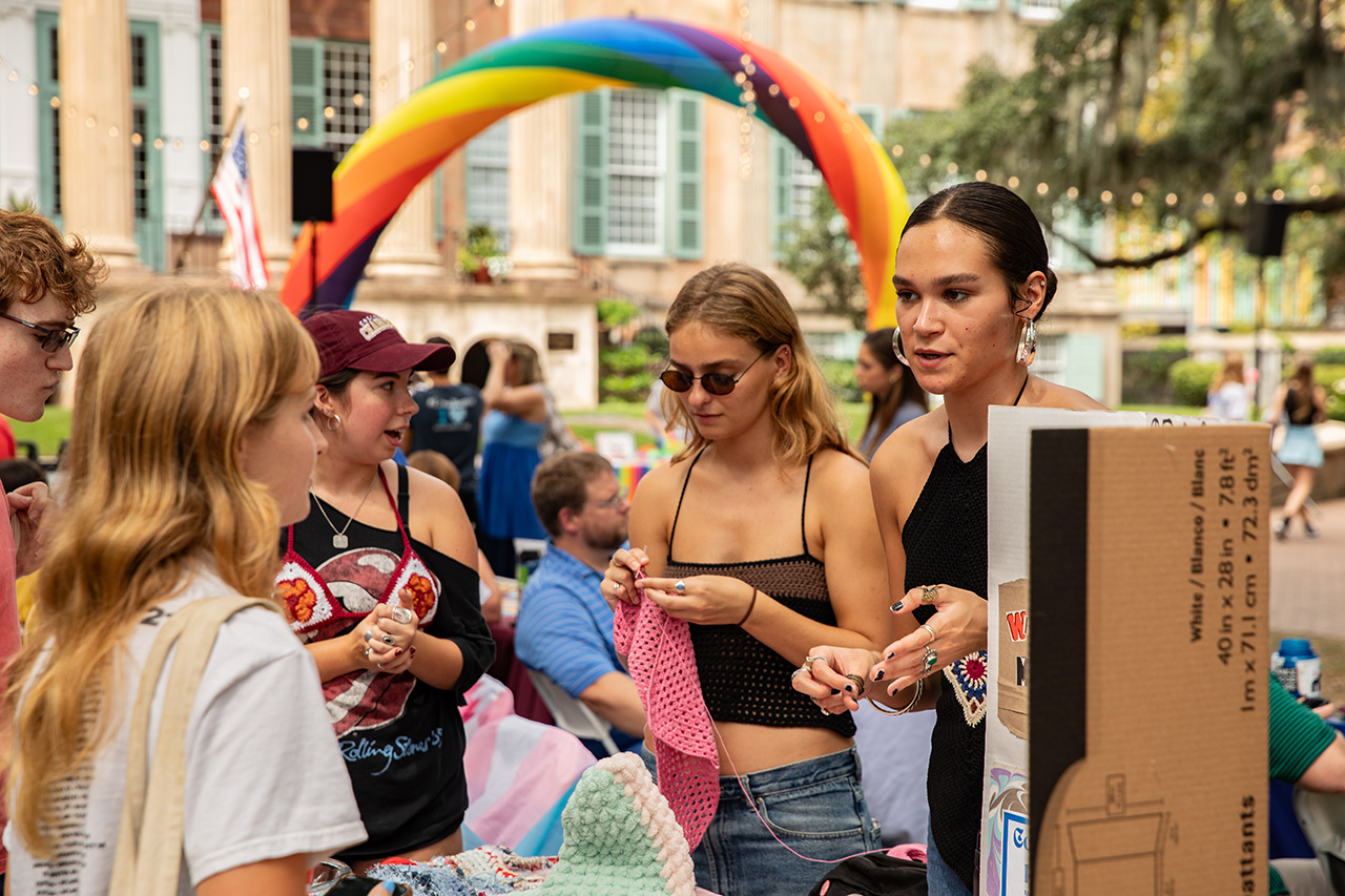 Student visits the Crochet Club's booth at the Involvement Fair.