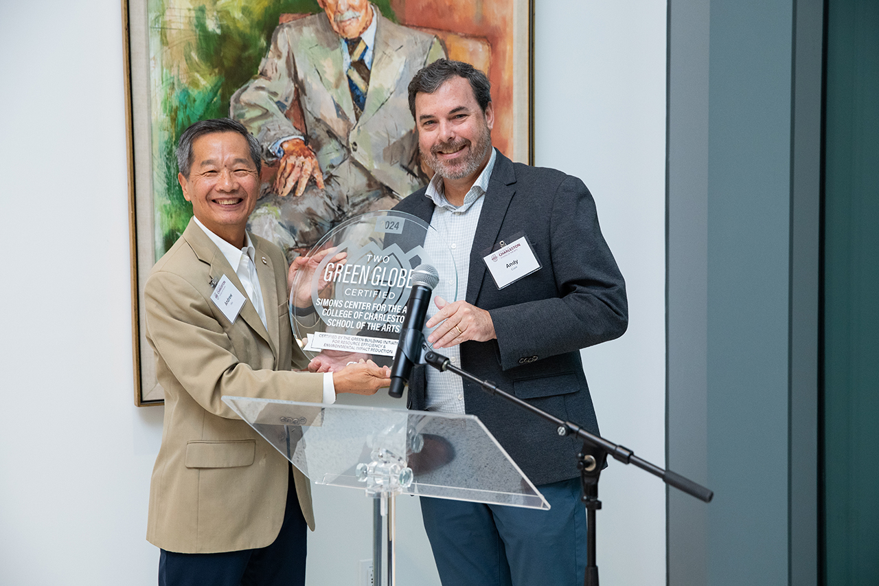 President Hsu poses with Green Award for the Simons Center 