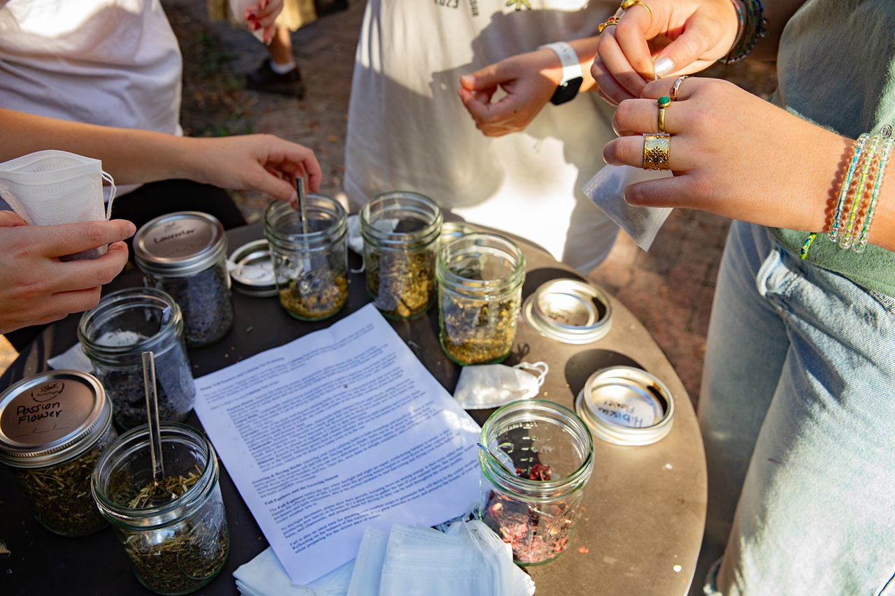 Students make personalized tea bags at Garden Work Day with locally grown herbs and dried plants.