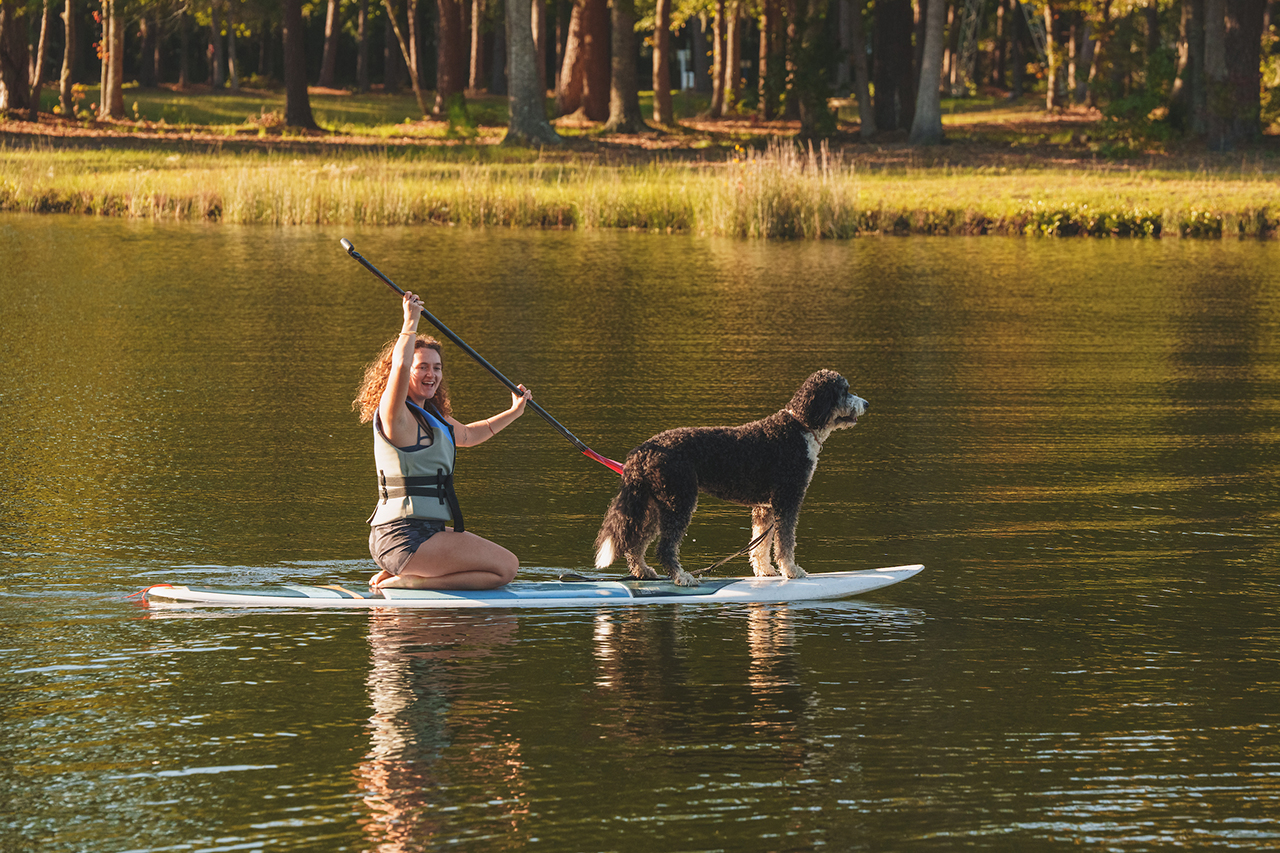 Girl paddles with dog at Trophy Lakes