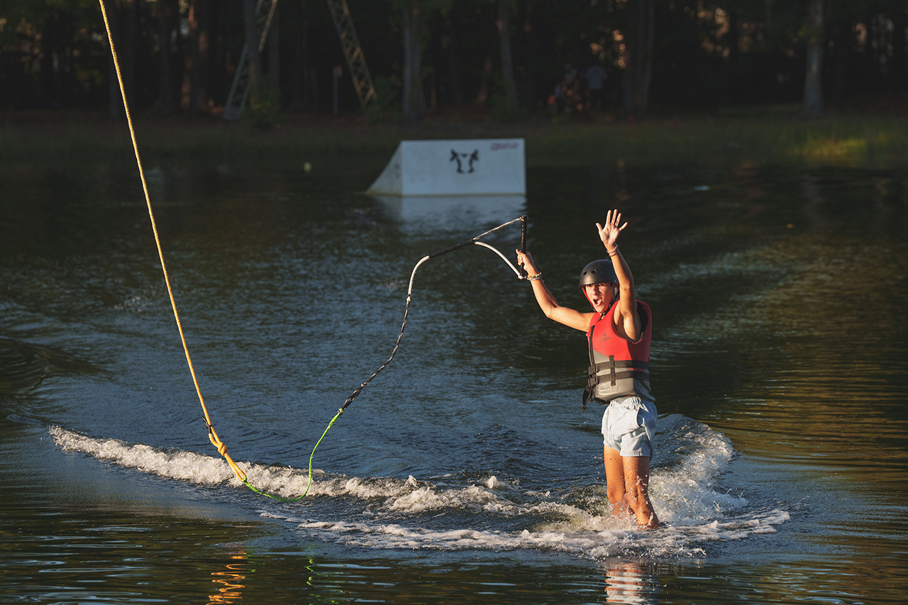 wake boarder waves a crowd