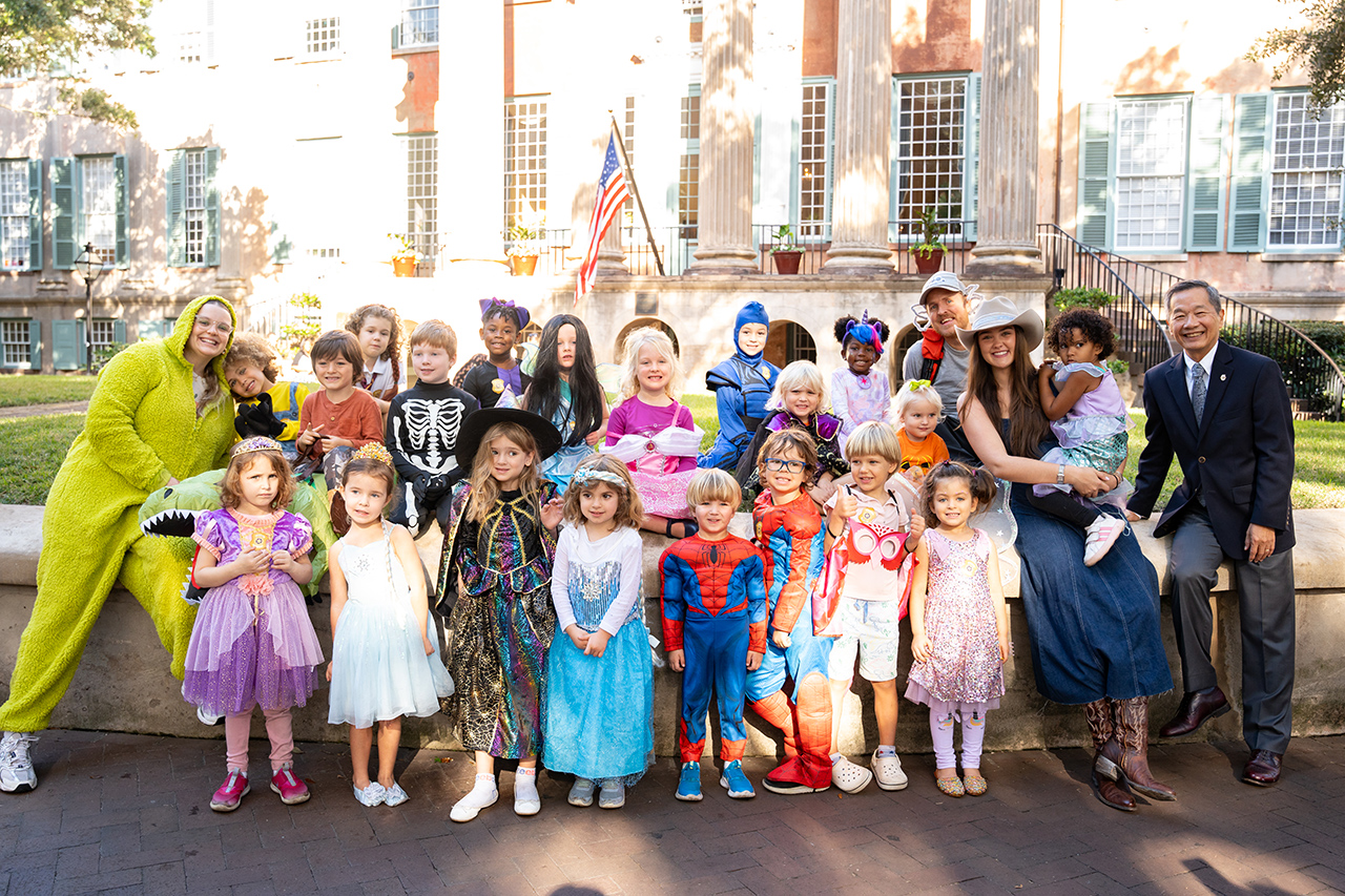 kids in costumes pose with President Hsu