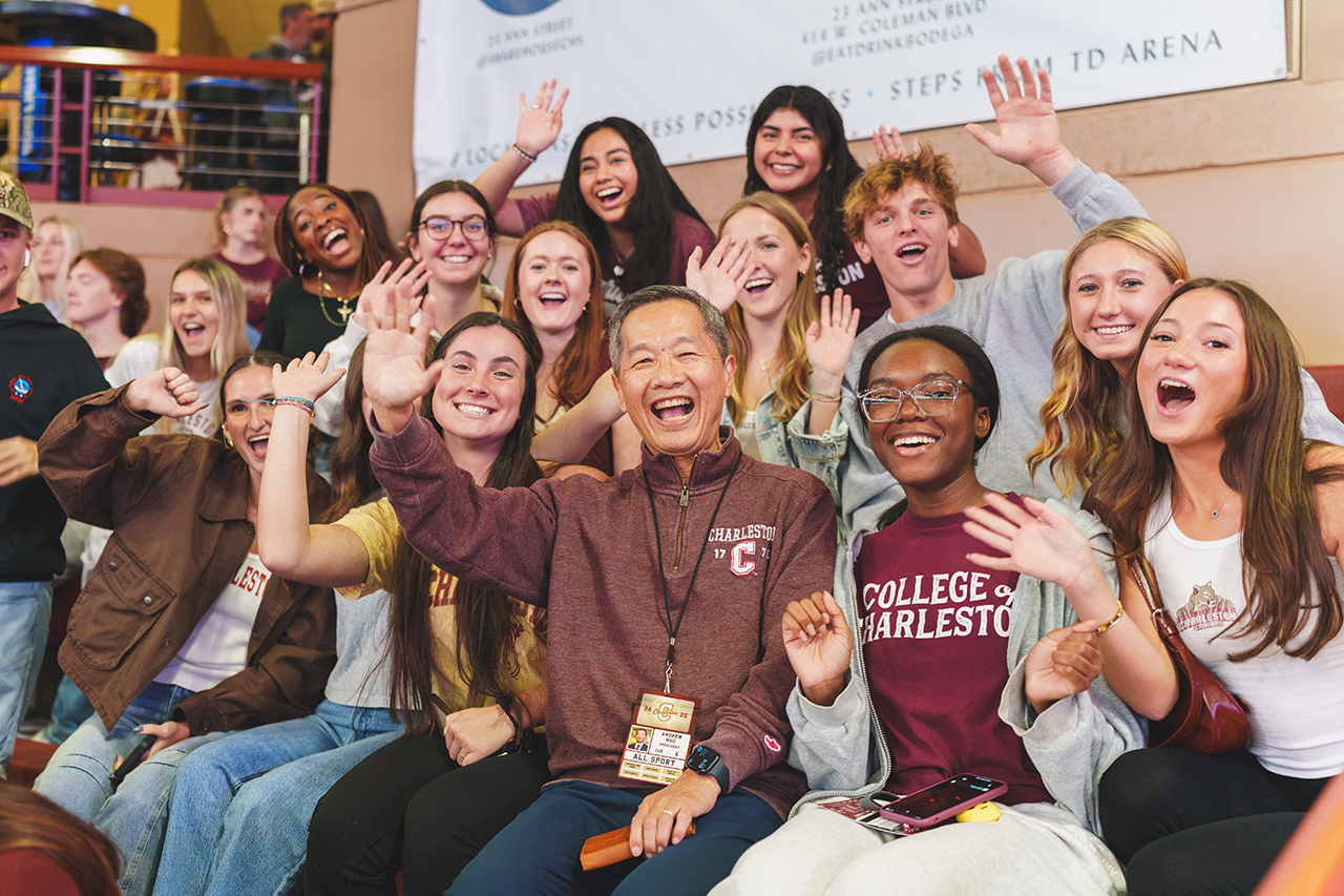 President Hsu cheers with students at College of Charleston Men's Basketball Team home game