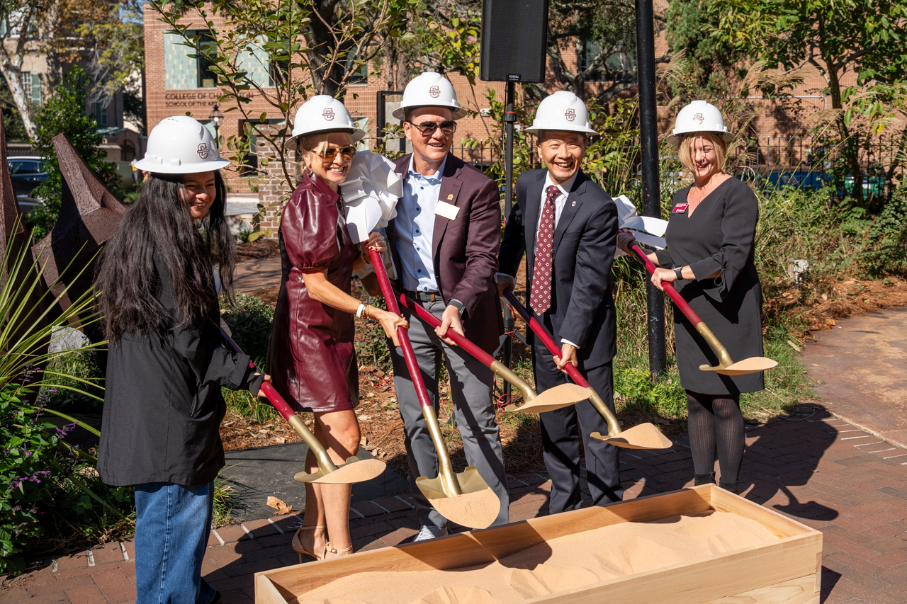 using shovel and sand for Tuccio Center groundbreaking ceremony 