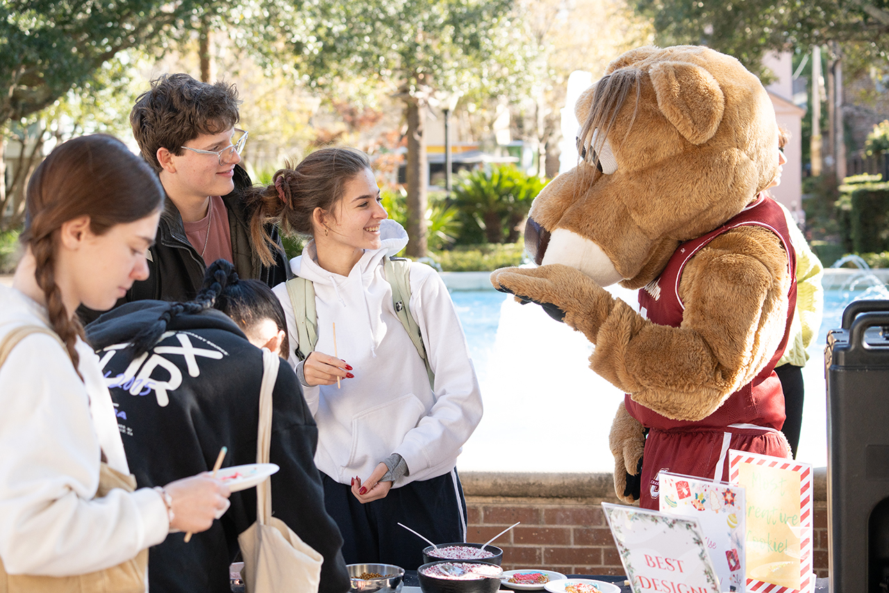 Clyde helps students make cookies during finals week for stress relief outside the library 