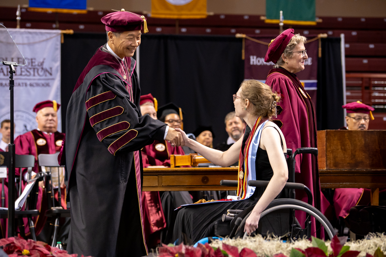 woman in wheelchair gets diploma in winter graduation at the College of Charleston